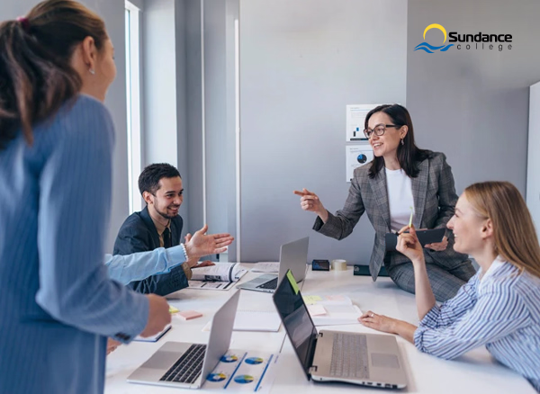 A group of human resources professionals discussing ideas during a workplace meeting.