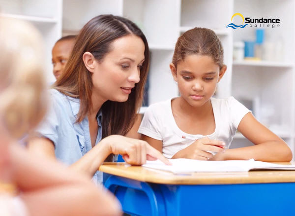 Education Assistant helping a student overcome a challenge.