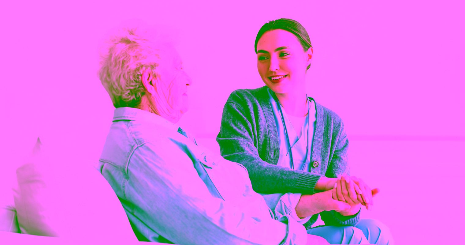 Home care personal support worker assists an elderly woman while holding her hand.
