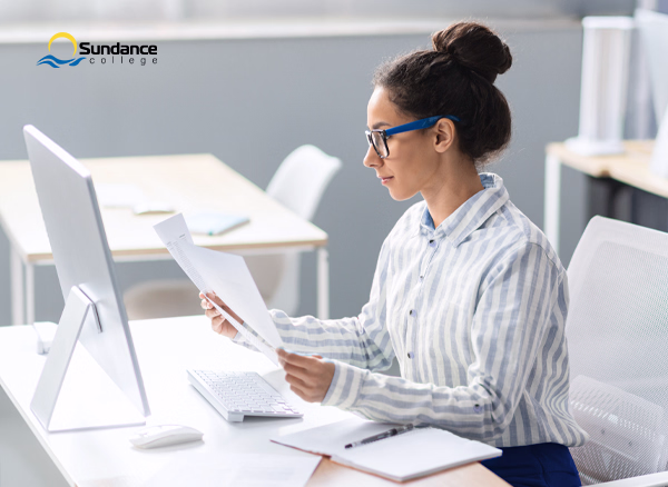 Accounting, tax, and payroll professional studying financial documents.