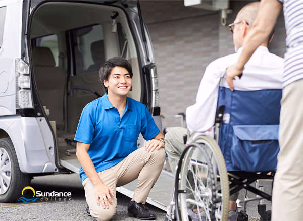 body personal support care worker outside a grey van ready to help an old man in a wheelchair up a ramp